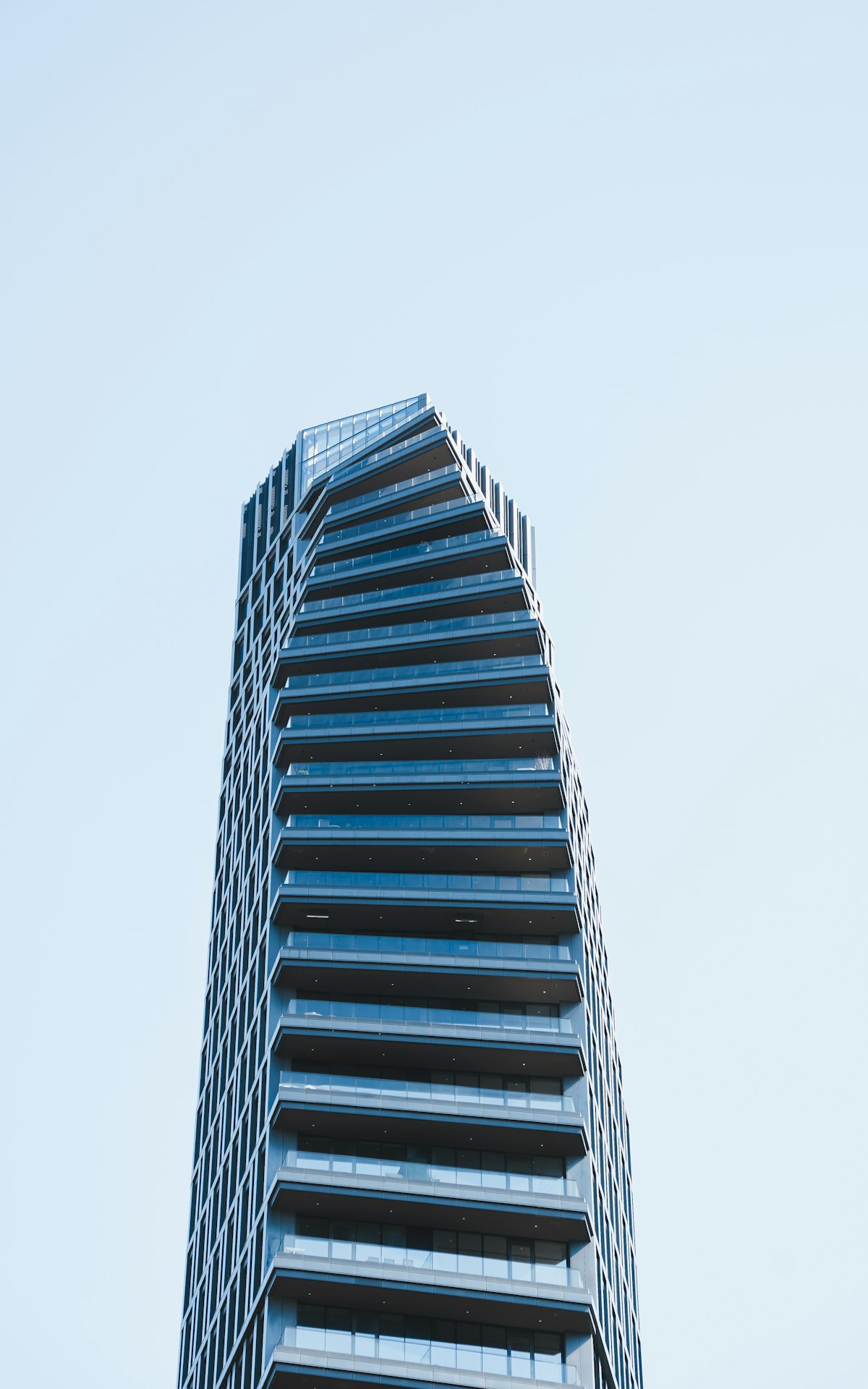 Tall residential tower against a blue sky